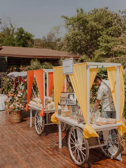 Fun food and activity carts, like this perfume bar, are a great way to make a Mehendi or carnival event interactive and memorable for guests.