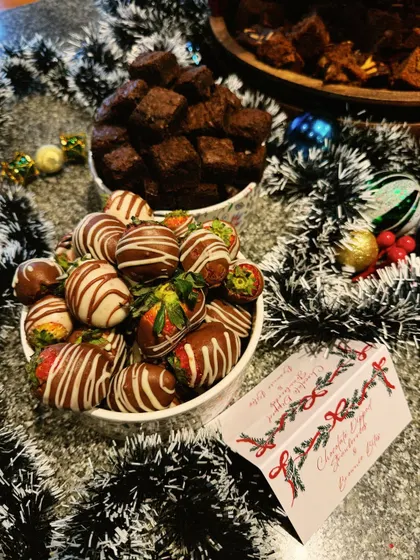A bowl of chocolate-dipped strawberries and brownie bites from a Christmas catering event. Simple, decadent, and always a crowd-pleaser.