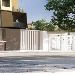 A street-level perspective of a residential property, showing how the gate, fencing, and building elements come together. Our site design considers the property's appearance from all public-facing angles.