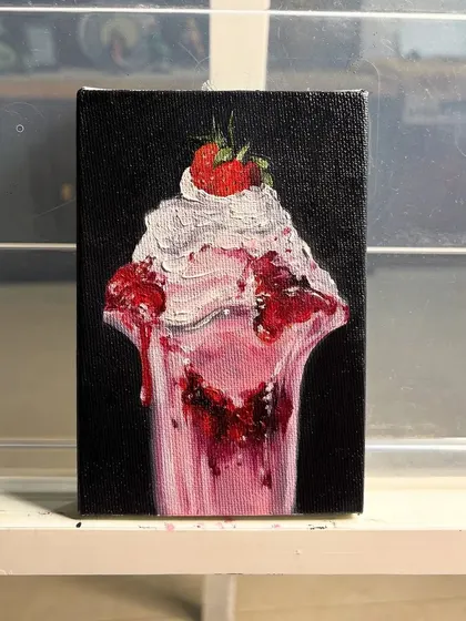 A miniature painting of a delicious strawberry sundae. I loved painting the texture of the whipped cream and the glossy drips of the strawberry sauce.