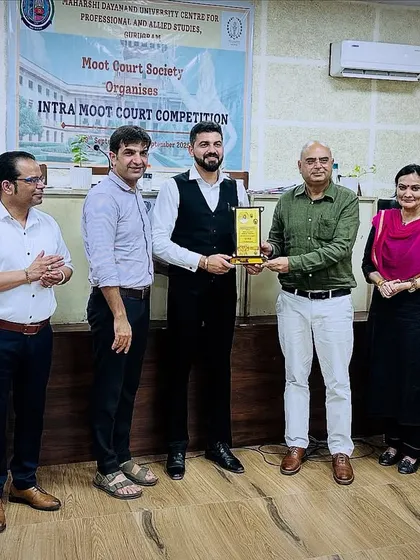 Receiving a token of appreciation after judging an Intra Moot Court Competition in Gurugram. It's always rewarding to contribute to the legal education community and interact with aspiring lawyers.