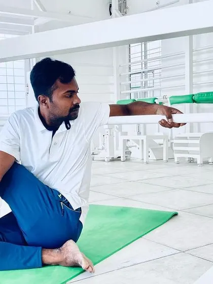 Ardha Matsyendrasana, or the half spinal twist, is shown here using a prop for support. This allows for a deeper and more stable twist, which is excellent for digestive health and spinal mobility.