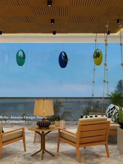 A view from the seating area of the brick-walled balcony, looking out. The combination of the slatted wood ceiling, comfortable chairs, and hanging planters creates an inviting atmosphere for enjoying your morning coffee or watching the sunset.