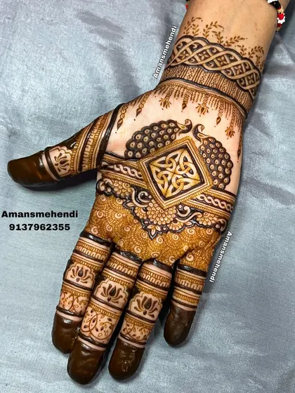 This unique design combines a Celtic knot in the center with traditional Indian peacock and lotus elements, showing how different styles can be blended beautifully.
