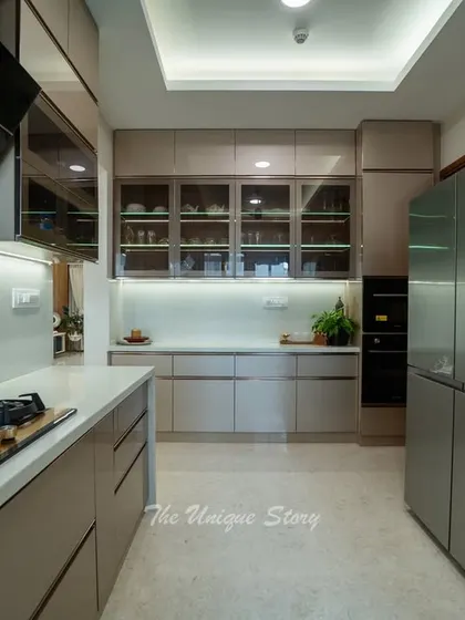 This perspective showcases the full length of the parallel kitchen, highlighting the abundant storage provided by floor-to-ceiling cabinets. A built-in oven is seamlessly integrated into the cabinetry for a clean, modern look.