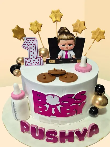 A "Boss Baby" themed cake for a first birthday. This fun design includes a baby bottle, cookies, and the iconic Boss Baby girl topper.