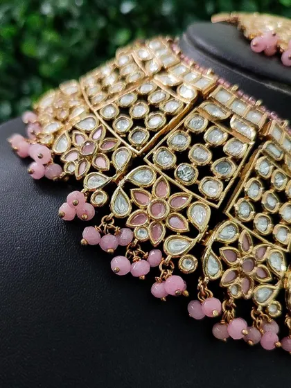 A detailed view of the pastel pink kundan choker from image 116. The floral motifs and delicate pink beadwork are perfect for a modern bride.
