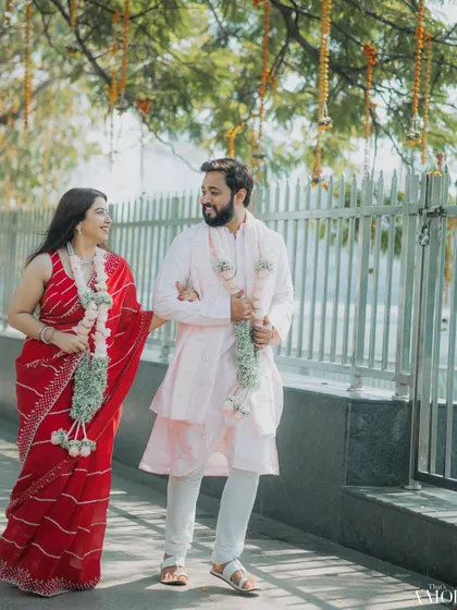 Capturing a sweet moment from a court marriage celebration. The couple, adorned with garlands, shares a walk, blending the simplicity of a civil ceremony with traditional touches.