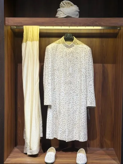 For the discerning groom, the wedding day is a defining moment. I create bespoke wedding couture, like this intricately detailed sherwani, that blends heritage with minimalist elegance. Every stitch is a promise of perfection for your most important celebration.