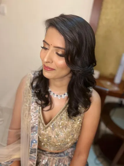 Another angle of Ritu's engagement look, showing how the soft curls frame her face. The subtle makeup ensures she looks radiant and natural in her photos.