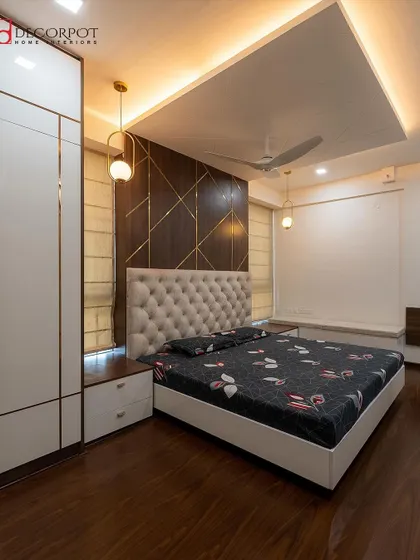 Another angle of the bedroom from image 127, highlighting the seamless integration of the wardrobe and bay window seating. The false ceiling with cove lighting adds to the room's luxurious ambiance.