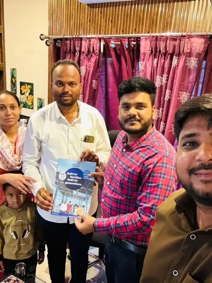 A family with young children holding our solar booklet. We believe in educating the next generation about renewable energy.