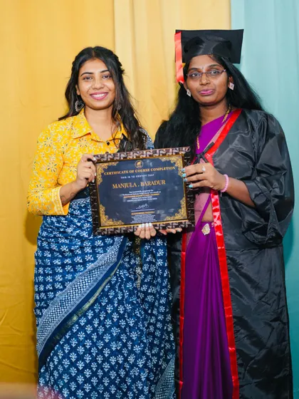 A proud teacher moment, handing over the certificate of completion.