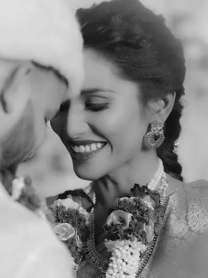 An intimate black and white close-up of the bride smiling at her groom. This candid shot beautifully captures the love and joy shared between them during the ceremony.