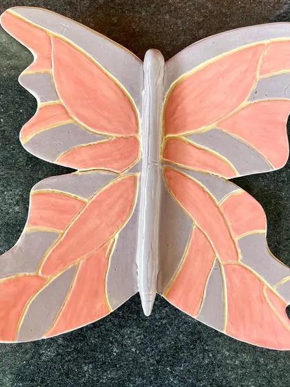 A beautiful, hand-painted butterfly wall decor piece, created by a student.