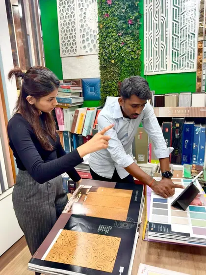 The design process is a partnership. Here, I am with a client in a showroom, reviewing digital mockups on a tablet and selecting the perfect laminates and finishes that match their vision.