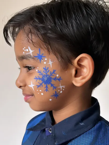 Chasing snowflakes and dreams. Practicing some winter-themed face paint designs, like this beautiful blue snowflake.