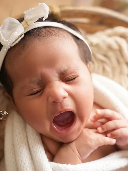 A perfectly timed capture of a big newborn yawn. These are the authentic, unscripted moments that add so much personality to your baby's first portraits.