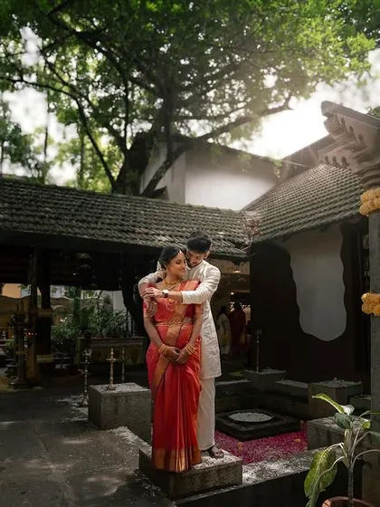 A portrait set against the beautiful architecture of a traditional home. The morning light and the serene setting create a peaceful atmosphere for the couple's portrait.
