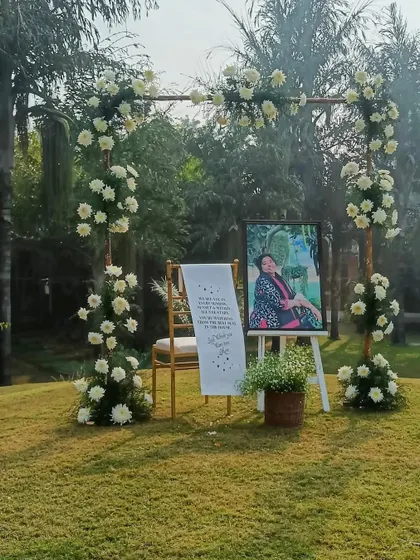A tribute corner is a beautiful way to honor loved ones. I created this special space with a photo, a heartfelt message, and elegant white floral arrangements to remember the client's mother on their special day.