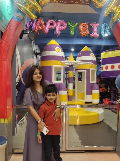 A mother and son pose for a photo during a birthday celebration. Our space is designed to create happy memories for the whole family.
