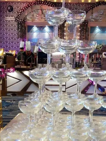 A classic champagne tower, a timeless symbol of celebration, ready for the couple's toast at their reception.