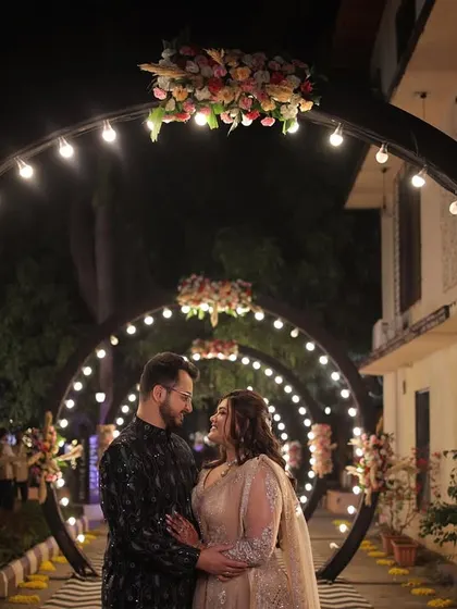 An enchanting Sangeet entrance with illuminated arches, creating a tunnel of light that leads guests into the celebration at The Orchid, Lonavala.