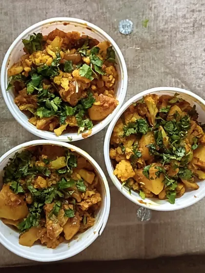Bowls of freshly made Aloo Gobhi sabzi, ready to be packed for orders. It's a simple, everyday dish that I cook with a lot of care.