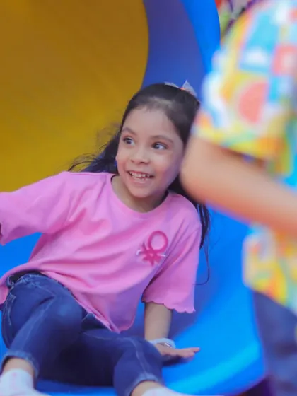 A happy smile from the bottom of the slide. Our play structures are designed to be safe and exciting, ensuring kids have a wonderful time.