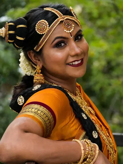 A stunning Brahmin bridal look, celebrating rich culture and tradition. The hairstyle, 9-yard saree drape, and makeup all come together to create an authentic and beautiful style.