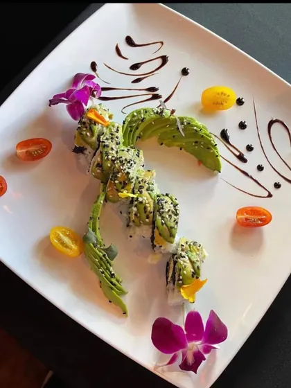 A vegetarian sushi roll presented in the shape of a dragon. This is a great example of how we can bring a playful and creative touch to our catering.