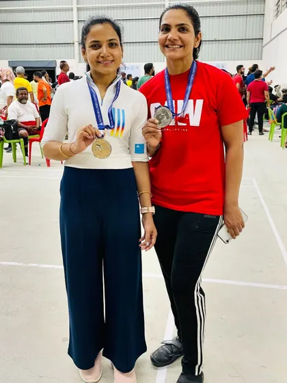 With a friend and fellow competitor, both with our medals. The powerlifting community is about supporting each other to be our best.