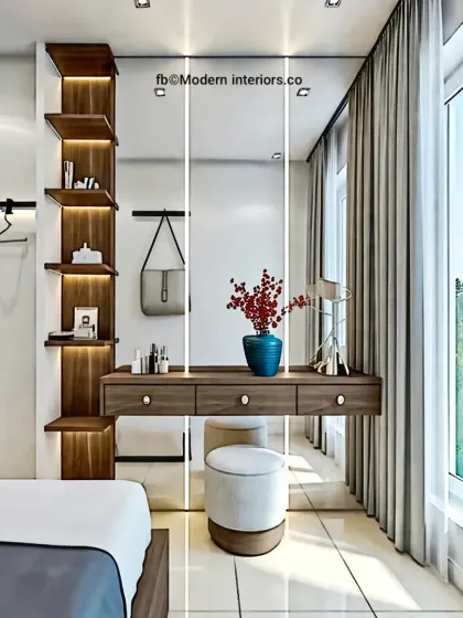 We created this modern dressing table setup within a bedroom. The floating vanity with drawers is paired with a tall, backlit mirror and a vertical shelving unit, providing a stylish and practical corner for makeup and accessories.