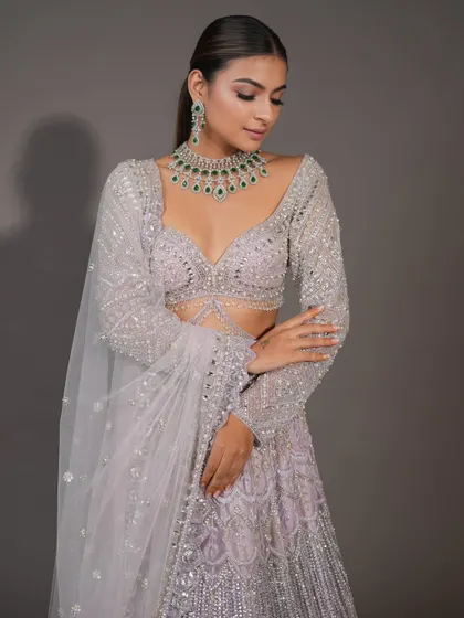 This pose highlights the intricate beadwork of the lehenga and the complementary makeup. I teach how to create a look that works in harmony with the client's entire ensemble.
