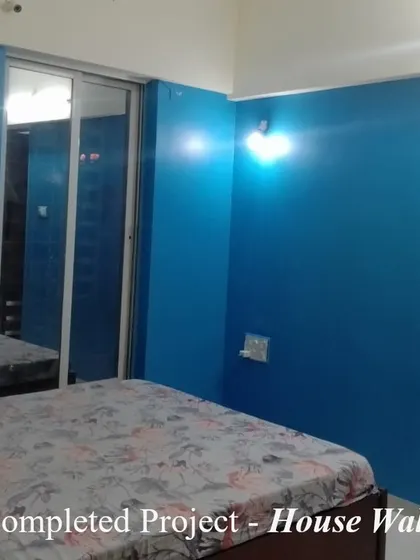 A bedroom featuring a striking blue accent wall that adds a pop of color and character. We carefully work around existing furniture and fixtures to deliver a clean, professional paint job with minimal disruption.