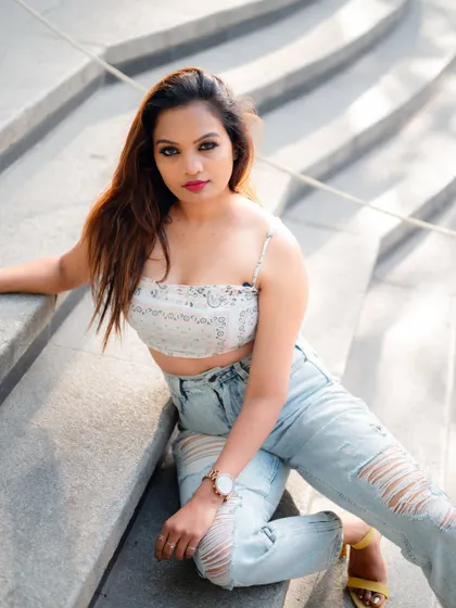 A duplicate of image 147, this relaxed portrait of a model sitting on stone steps is a beautiful and effortless fashion image.