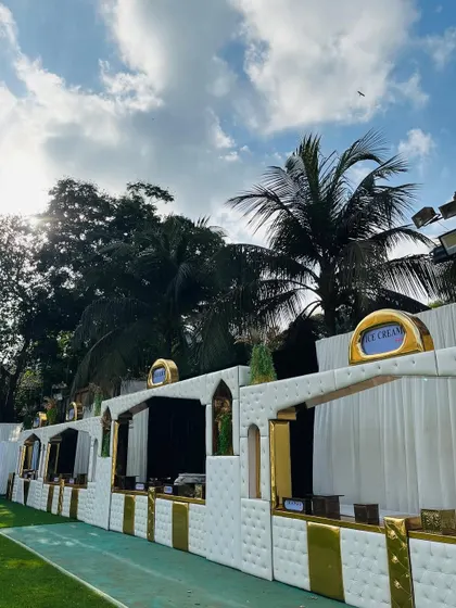 The white and gold counters during the day, set against palm trees and a blue sky.