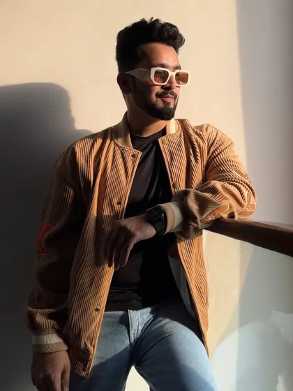 A relaxed, sun-kissed shot showing off a more casual, urban look with a corduroy jacket. It's about looking good both on and off the stage.
