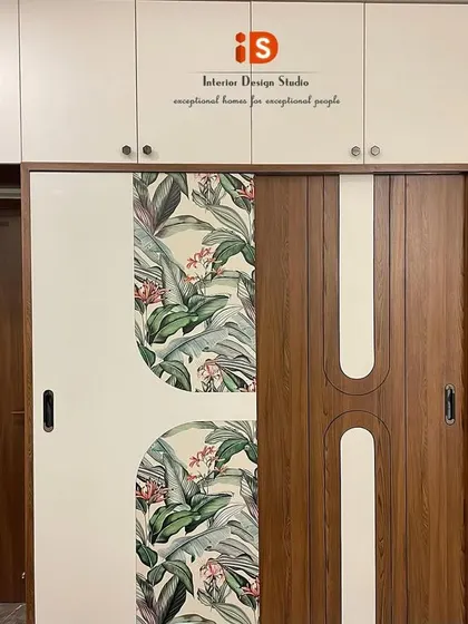 The sliding wardrobe in the "Go Green" guest bedroom, featuring a custom design that incorporates the same wood and botanical print from the headboard for a perfectly coordinated look.