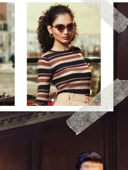 This John Jacobs Eyewear campaign shot features a retro-inspired look. The model's striped top and cat-eye sunglasses are styled to evoke a timeless, classic fashion sense that highlights the product's versatility.