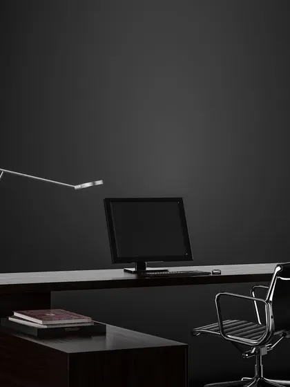 A minimalist home office concept designed for focus. The clean lines of the desk, ergonomic chair, and adjustable task lighting create a functional workspace that is free from distractions and high on style.