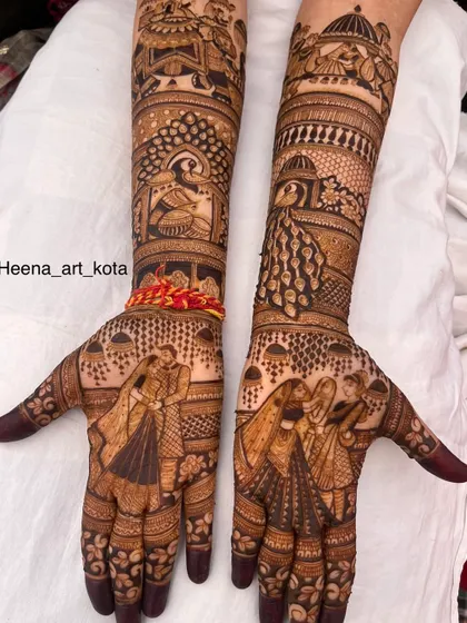 A beautiful and intricate full bridal design featuring couple portraits and peacock motifs.