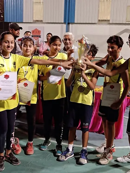 A glimpse of a tournament-winning moment. The smiles and certificates say it all.