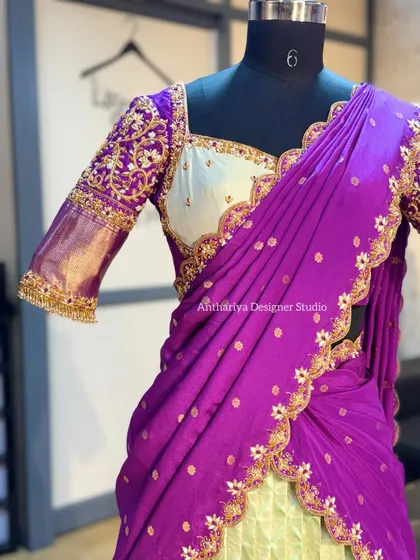 A detailed shot of the hand-embroidered blouse sleeve, featuring intricate floral motifs in gold thread.