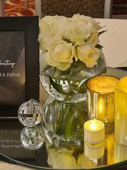 Another table centerpiece detail from the Sangeet. The mirrored base reflects the candlelight and the mini disco ball, adding extra sparkle and tying into the glamorous theme of the night.