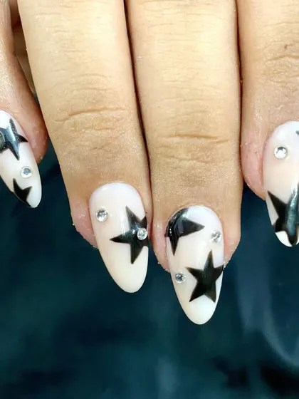 For the rockstars. This set features bold black stars on a milky white base, accented with rhinestones for extra sparkle.