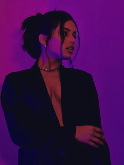 A profile shot that uses the colored light to sculpt the face and create a mysterious, artistic mood.