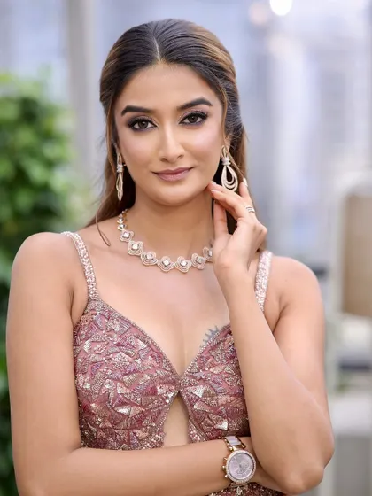 Modern elegance for a cocktail or reception night. This look features defined, shimmery eyes with delicate rhinestone details, contoured cheeks, and a sophisticated nude lip for a truly show-stopping effect.