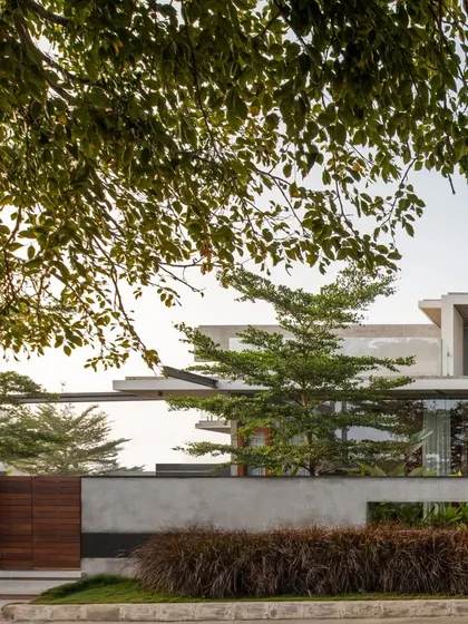 The finished Quarry House, where the raw concrete volumes are now integrated with a lush landscape and refined architectural details, creating a dialogue between the building and nature.