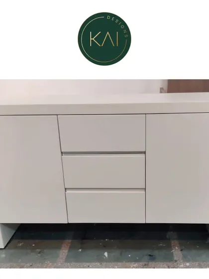 A simple and modern white sideboard with three central drawers and two cabinets. This versatile piece is shown in our workshop, ready for customization or delivery.